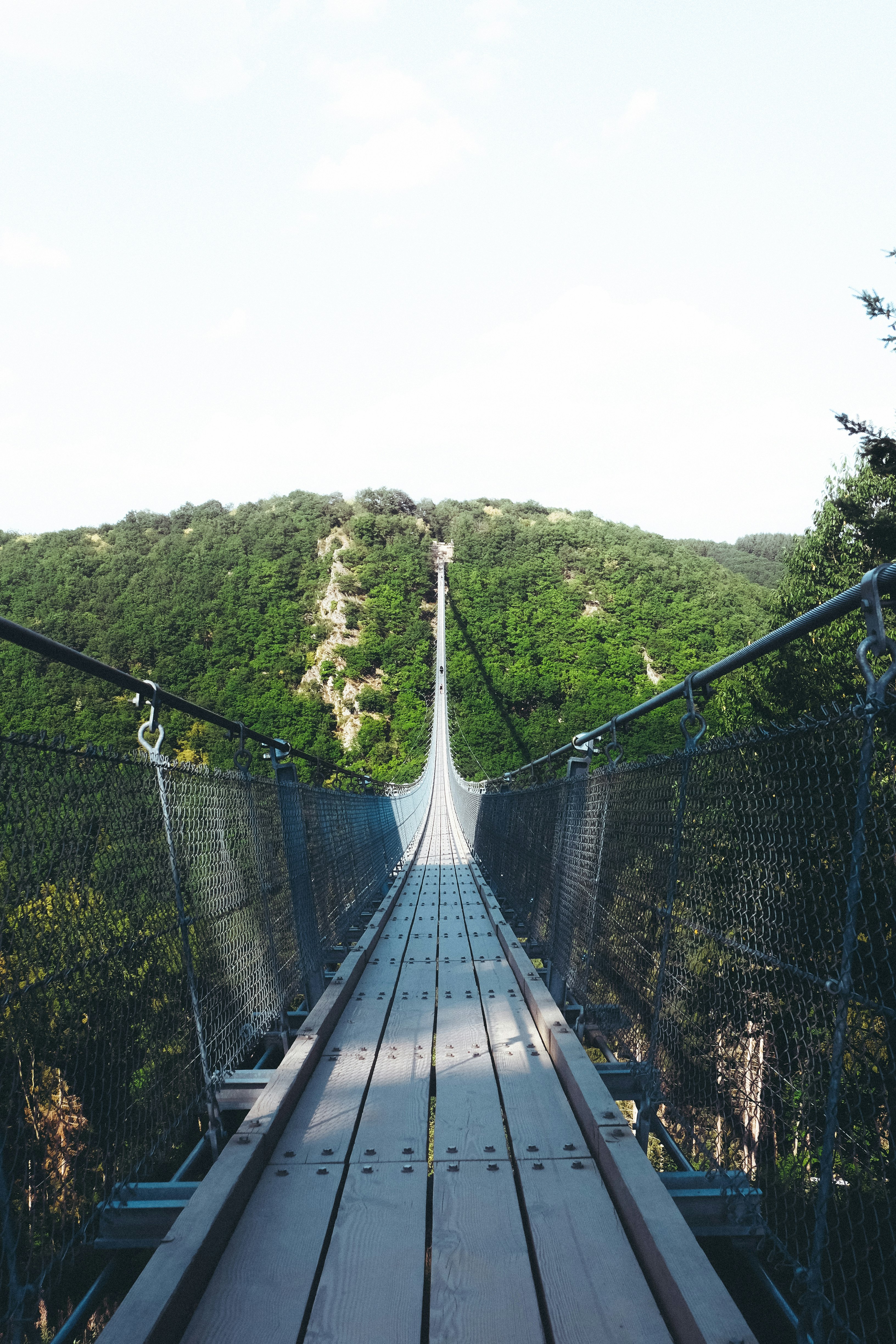 brown and gray bridge near mountain peak